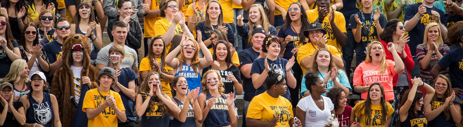 Student cheering at a football game.